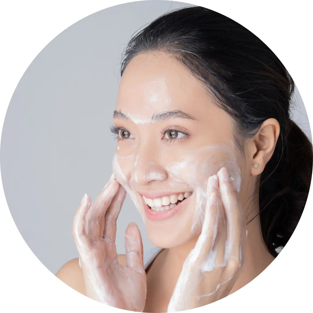 Woman using facial cream cleanser