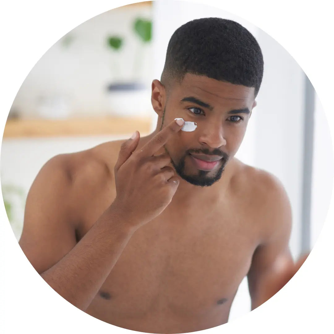 black man applying Buddha Beauty Vegan skincare to his face, mens skincare collection, mens products
