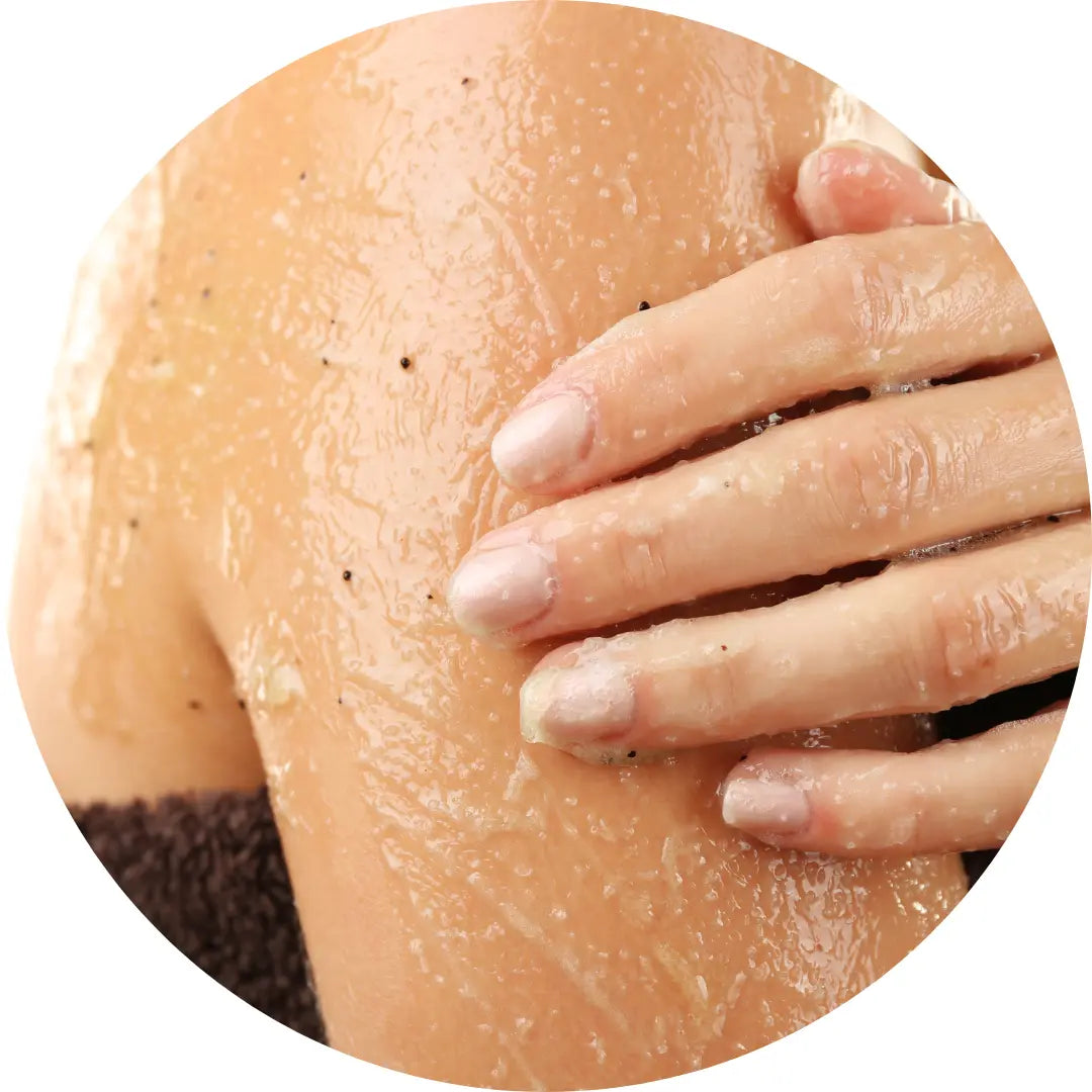 Buddha Beauty Skincare vegan and cruelty free body scrubs, woman applying body scrub to her shoulder