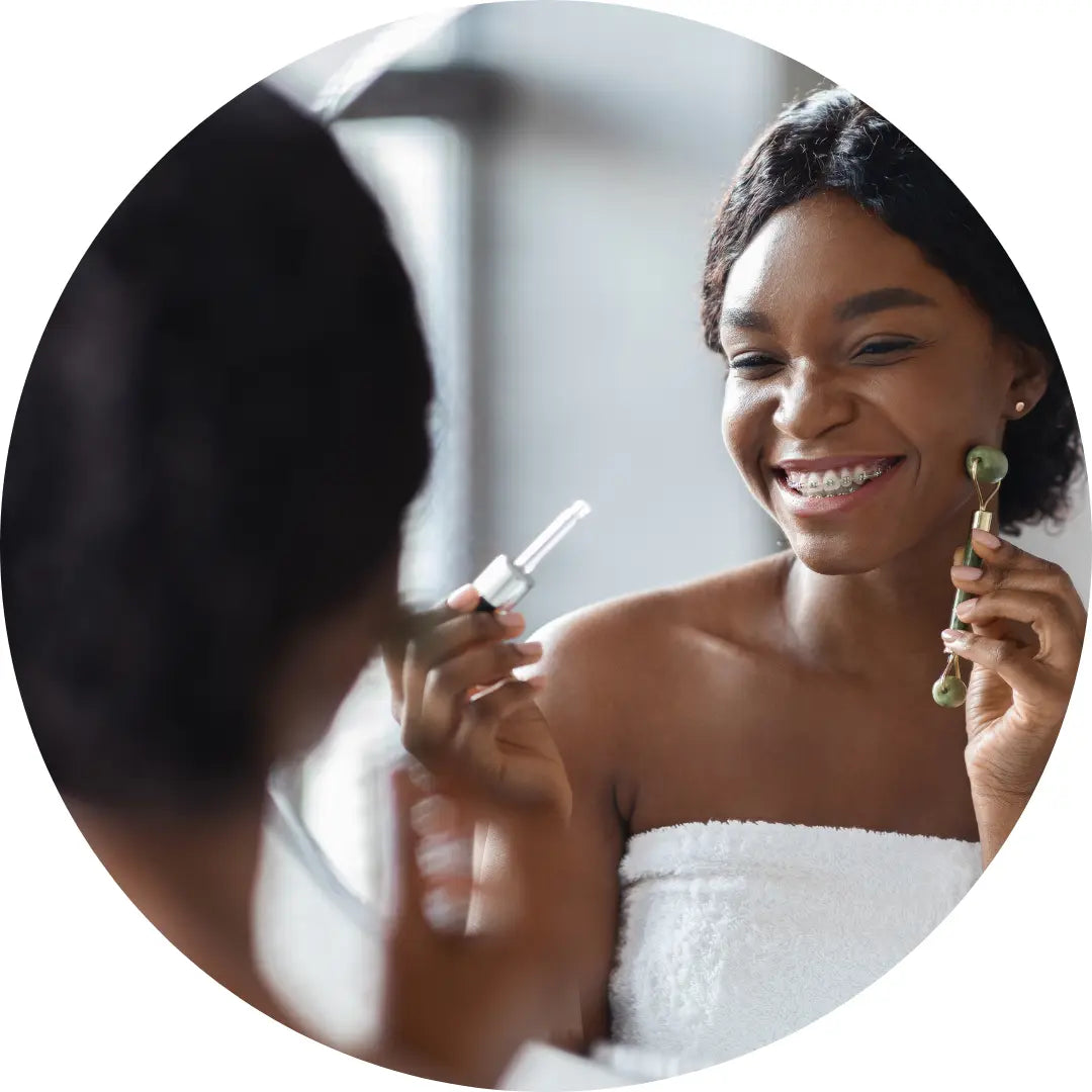 Black woman using a Buddha Beauty Jade Facial Roller