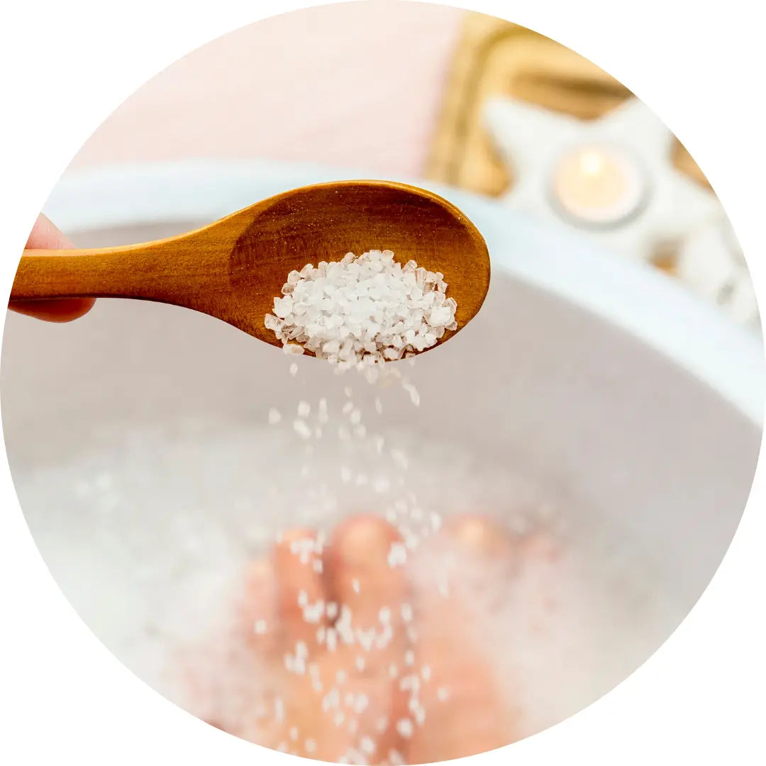 Buddha Beauty Vegan Bath salts being poured into a bath