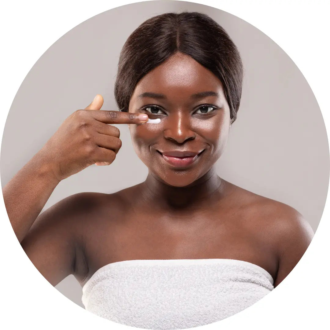 black woman applying buddha beauty eye cream 